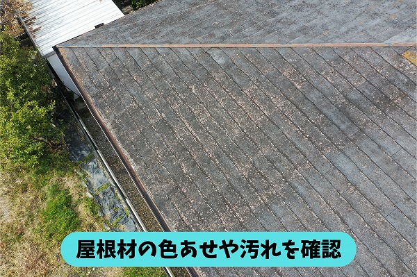 春日井市岩成台の住宅のスレート屋根。屋根材の色あせや汚れなどの経年変化を確認している様子